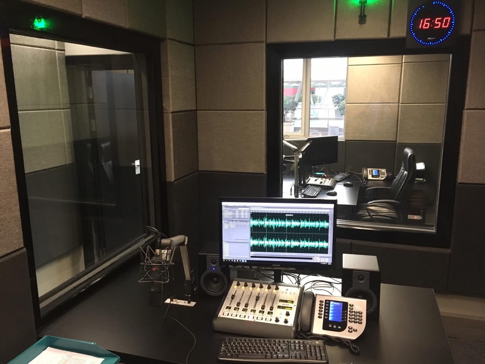 Radio studio mixing console with playout and automation screens