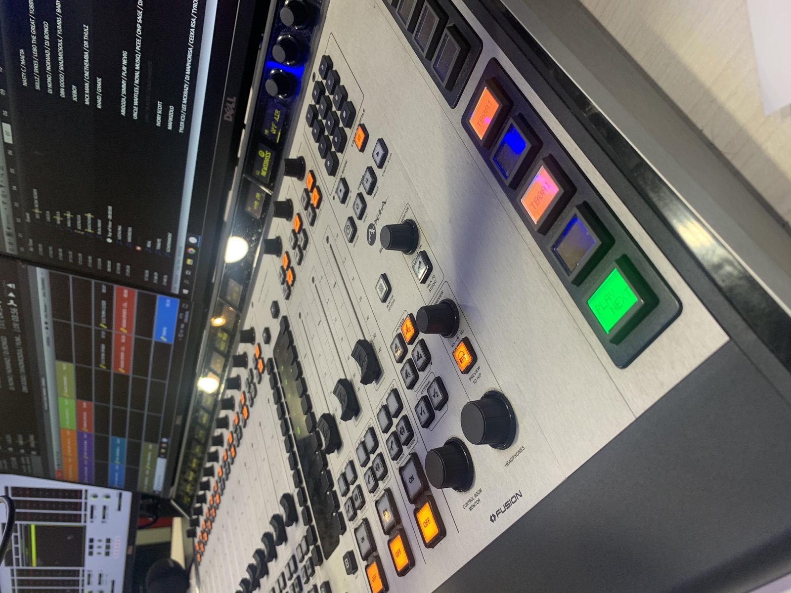 Professional radio studio with microphones, acoustic panels, and broadcast furniture
